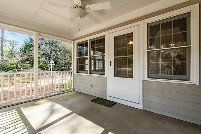 unfurnished sunroom featuring a wealth of natural light and ceiling fan