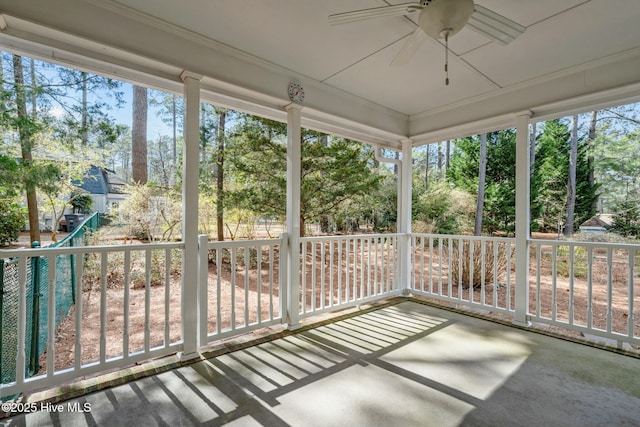 unfurnished sunroom with plenty of natural light and ceiling fan