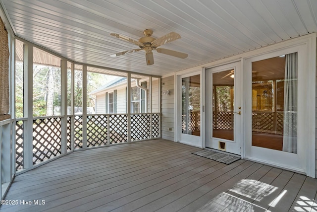 unfurnished sunroom featuring ceiling fan