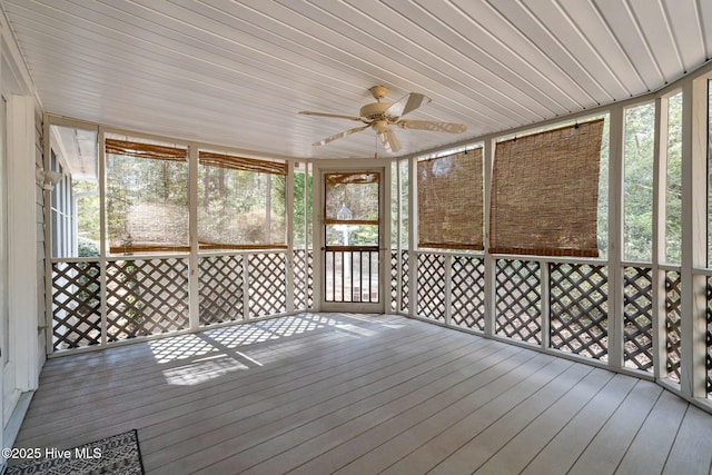 unfurnished sunroom with wooden ceiling and a ceiling fan