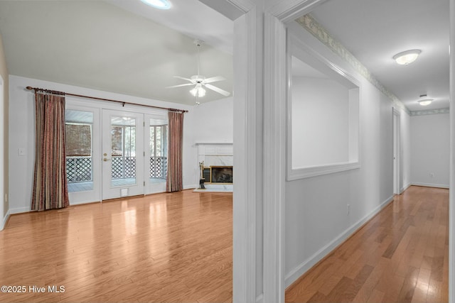 interior space featuring french doors, baseboards, and wood finished floors