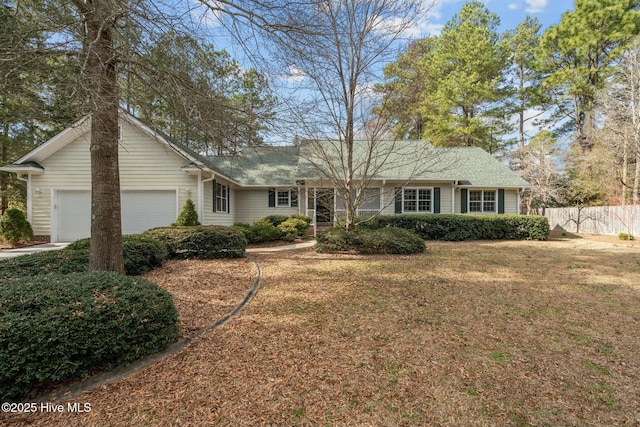 single story home featuring a front lawn, fence, and a garage