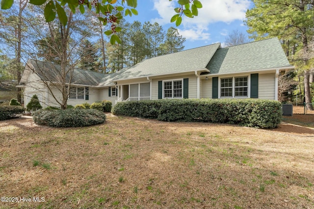 single story home with a front lawn and a shingled roof