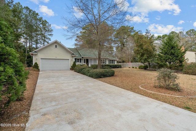 ranch-style home with driveway, a garage, and fence