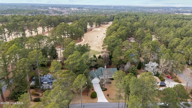 birds eye view of property with a view of trees