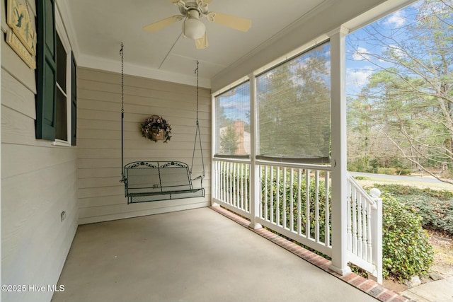 unfurnished sunroom with a ceiling fan