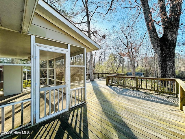 wooden deck featuring a sunroom