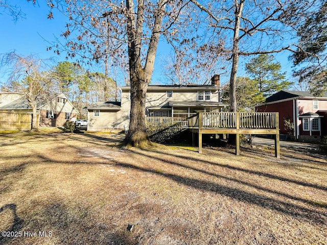 view of yard with a deck, stairs, and fence