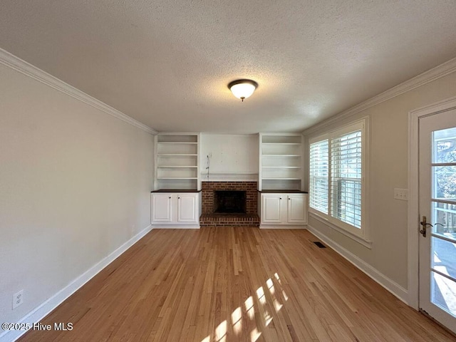 unfurnished living room with baseboards, a fireplace, a textured ceiling, and light wood-style floors