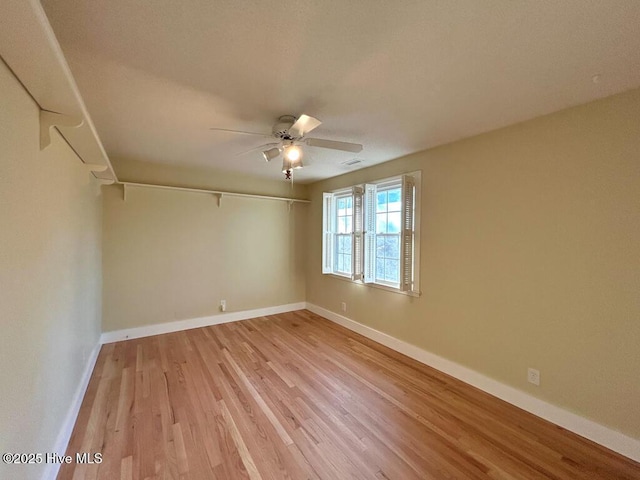 empty room with light wood-style flooring, baseboards, and ceiling fan