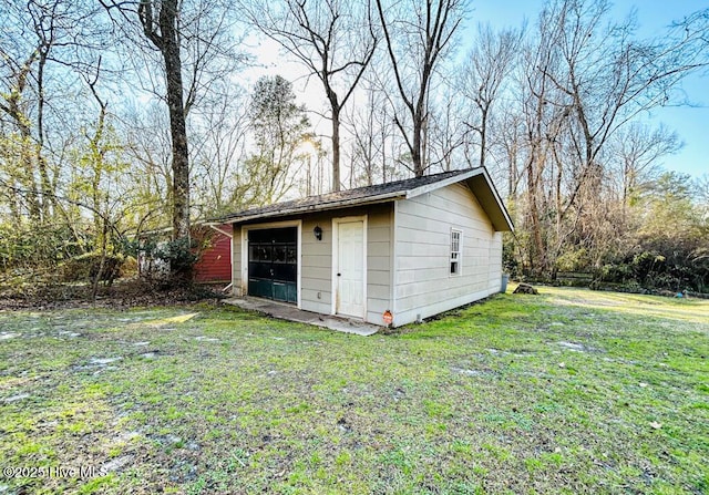 view of outdoor structure with a garage and an outbuilding