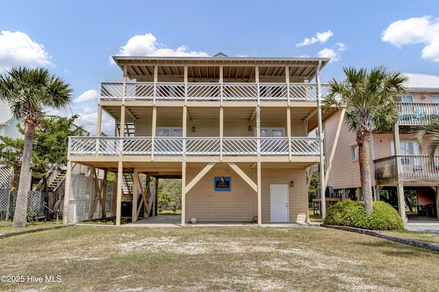 raised beach house featuring stairs