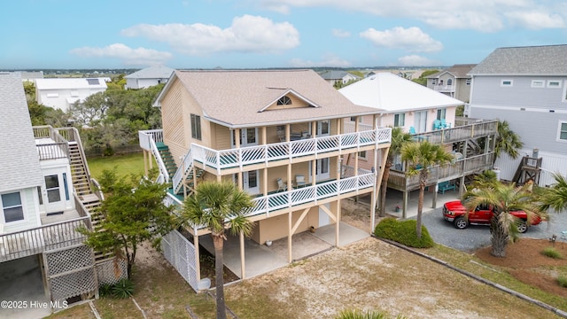 exterior space featuring stairs, a residential view, and driveway