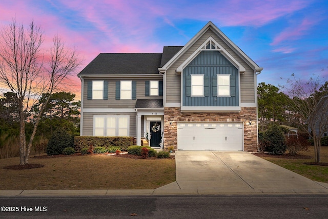 traditional-style home with board and batten siding, concrete driveway, a garage, and stone siding