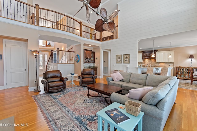 1807 Baywater Ct SE, Bolivia, NC 28422 - living area featuring light wood-style floors, stairway, a towering ceiling, and baseboards
