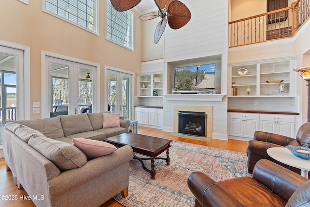 1807 Baywater Ct SE, Bolivia, NC 28422 - living room with light wood finished floors, a towering ceiling, ceiling fan, and a healthy amount of sunlight