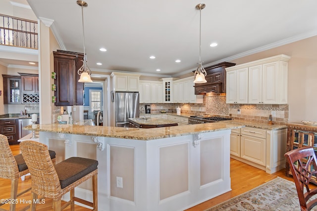1807 Baywater Ct SE, Bolivia, NC 28422 - kitchen featuring freestanding refrigerator, glass insert cabinets, a kitchen breakfast bar, and ornamental molding