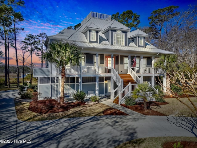 1807 Baywater Ct SE, Bolivia, NC 28422 - coastal home with stairway, covered porch, and metal roof