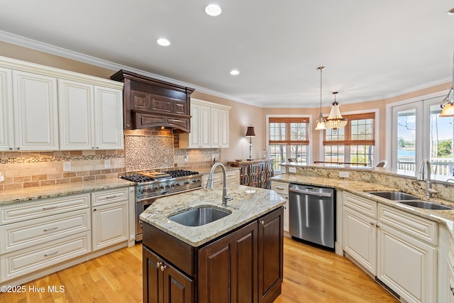 1807 Baywater Ct SE, Bolivia, NC 28422 - kitchen with light wood finished floors, a sink, backsplash, and appliances with stainless steel finishes