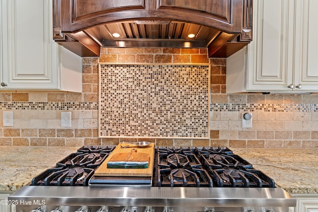 1807 Baywater Ct SE, Bolivia, NC 28422 - kitchen featuring gas range oven, light stone countertops, custom exhaust hood, and decorative backsplash