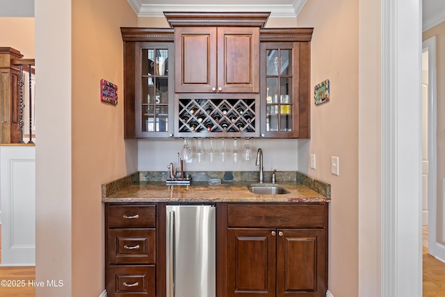 1807 Baywater Ct SE, Bolivia, NC 28422 - bar with indoor wet bar, crown molding, a sink, and freestanding refrigerator
