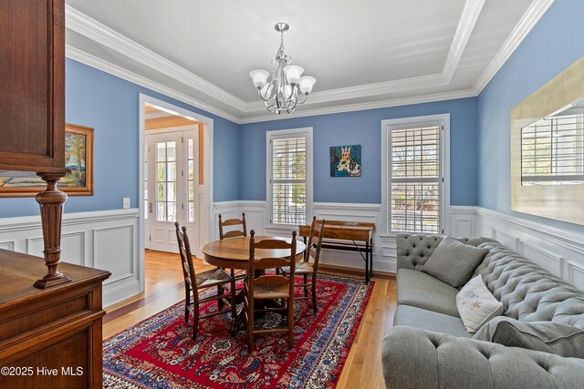 1807 Baywater Ct SE, Bolivia, NC 28422 - dining room featuring a chandelier, light wood-style flooring, and wainscoting