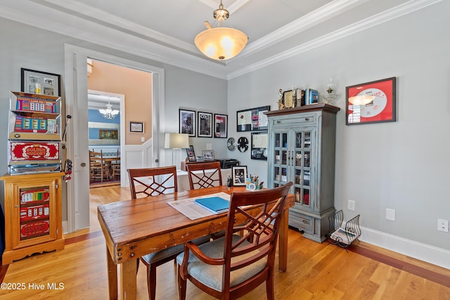 1807 Baywater Ct SE, Bolivia, NC 28422 - dining space with an inviting chandelier, crown molding, and light wood-style floors