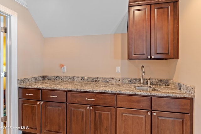 1807 Baywater Ct SE, Bolivia, NC 28422 - interior space featuring light stone countertops, vaulted ceiling, and a sink