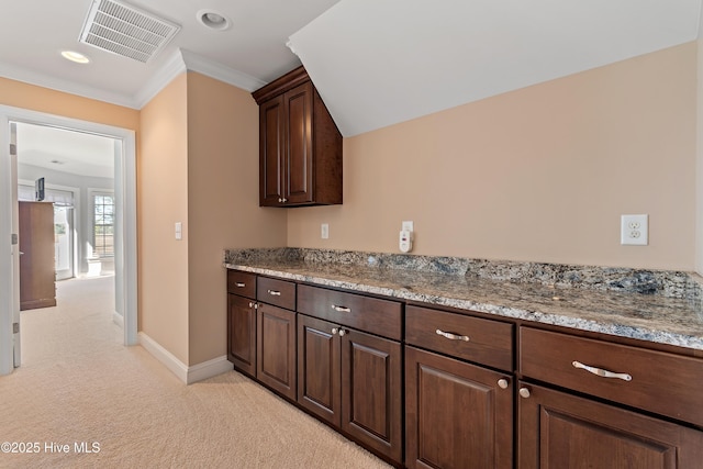 1807 Baywater Ct SE, Bolivia, NC 28422 - kitchen featuring visible vents, crown molding, baseboards, dark brown cabinetry, and light colored carpet