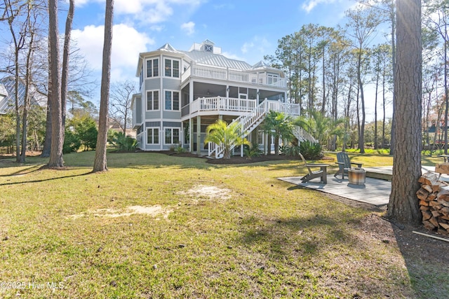 1807 Baywater Ct SE, Bolivia, NC 28422 - back of property with stairs, a balcony, a patio area, a lawn, and a sunroom