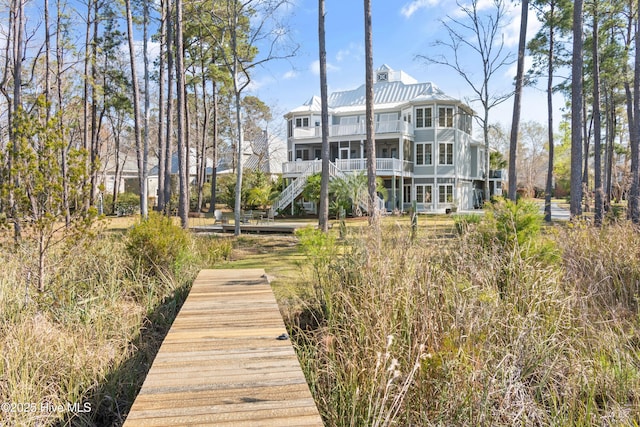 1807 Baywater Ct SE, Bolivia, NC 28422 - rear view of property featuring stairway, a balcony, and metal roof