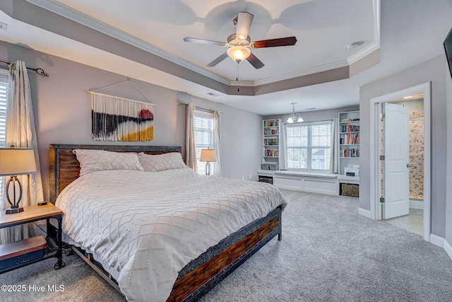 bedroom with ornamental molding, a tray ceiling, carpet, baseboards, and ceiling fan