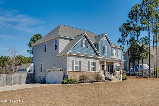 craftsman-style home with driveway, stone siding, a porch, fence, and a garage