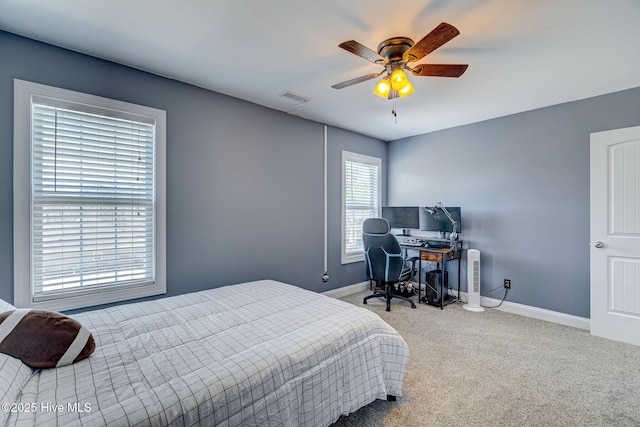 carpeted bedroom with a ceiling fan, baseboards, and visible vents