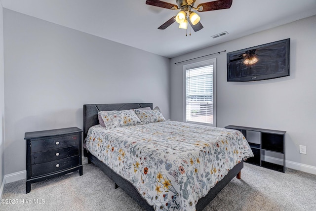 carpeted bedroom with visible vents, ceiling fan, and baseboards