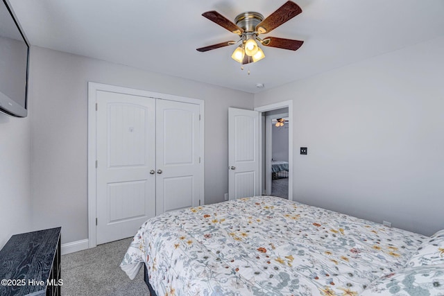 carpeted bedroom with baseboards, a closet, and ceiling fan