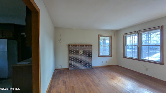 spare room with wood finished floors and baseboards