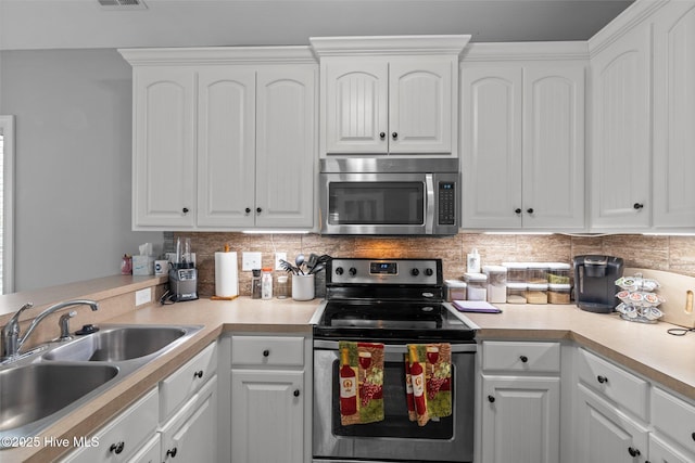 kitchen featuring a sink, stainless steel appliances, and white cabinetry