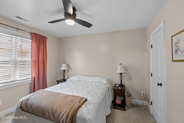 carpeted bedroom featuring a ceiling fan, baseboards, and visible vents