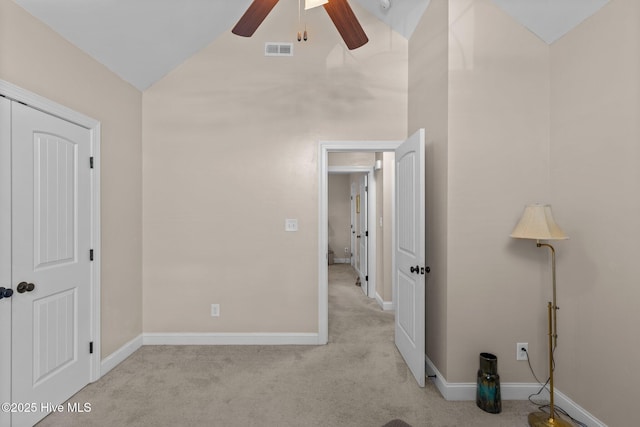 unfurnished bedroom with visible vents, ceiling fan, baseboards, vaulted ceiling, and carpet flooring