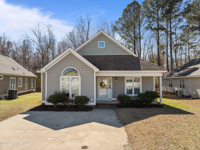 view of front of house featuring central air condition unit, covered porch, a front yard, and roof with shingles