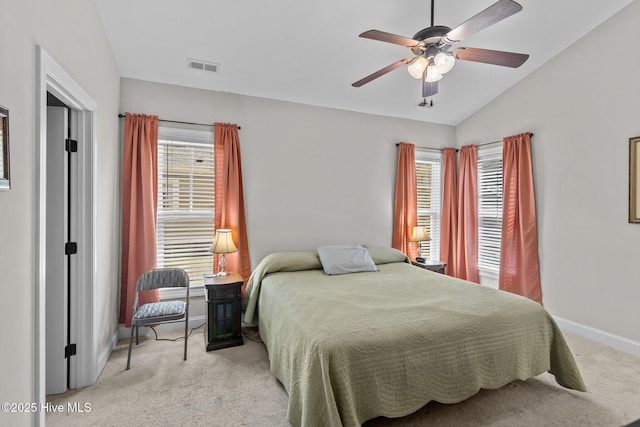 bedroom with a ceiling fan, baseboards, visible vents, lofted ceiling, and light carpet