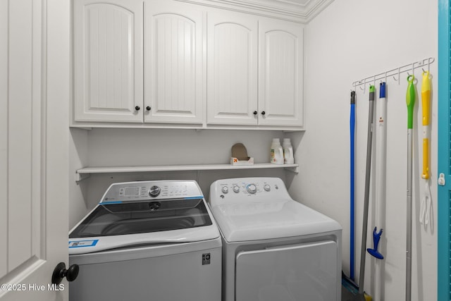 laundry area featuring cabinet space and washing machine and clothes dryer