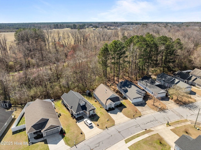 bird's eye view with a wooded view and a residential view