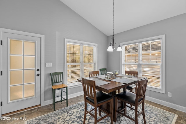 dining area with lofted ceiling, a notable chandelier, and baseboards