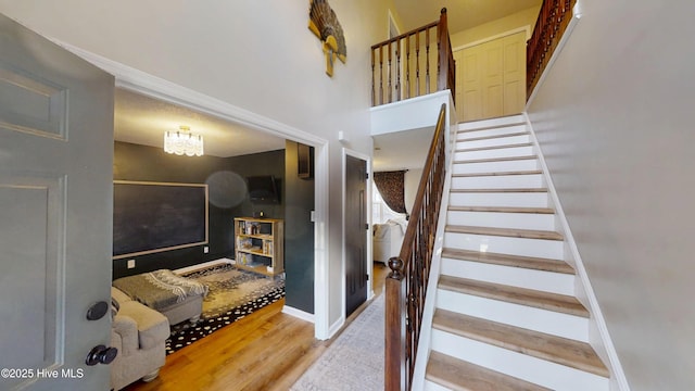 staircase with baseboards and wood finished floors