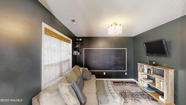 interior space featuring visible vents, baseboards, and a notable chandelier