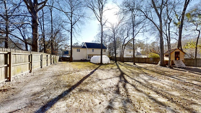 view of yard featuring a playground and a fenced backyard