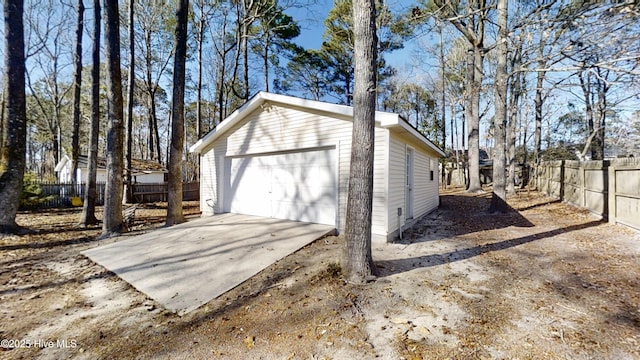 detached garage featuring fence