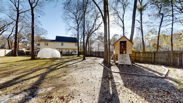 view of yard with a fenced backyard and a playground